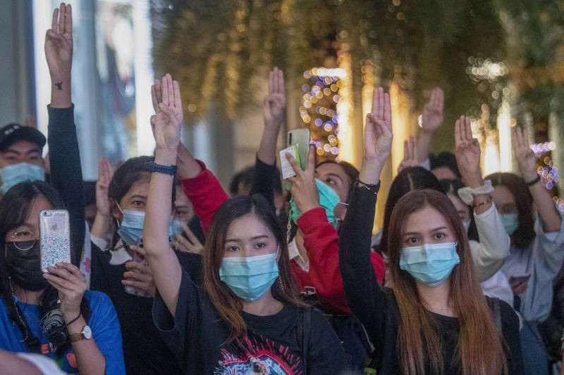 Pro-democracy activists flash three-fingered salutes during a rally outside Siam Paragon, one of the largest shopping malls, in Bangkok, Thailand, Tuesday, October 20, 2020. (Photo by Sakchai Lalit/AP Photo)